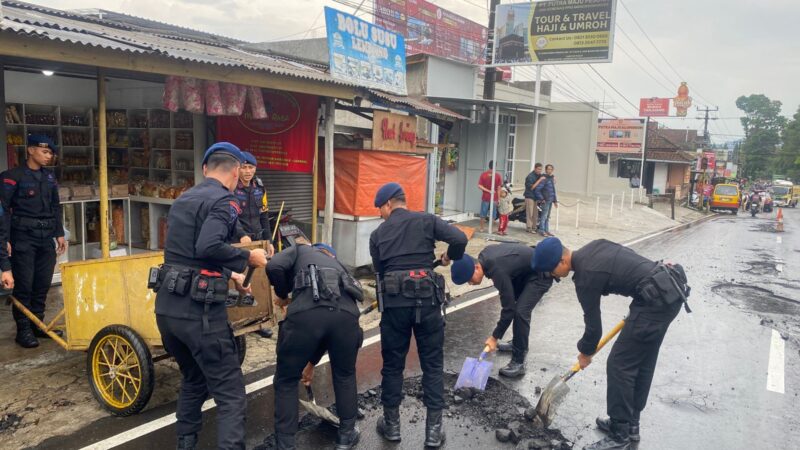 Sat Brimob Polda Jabar Bersihkan Material Pasir dan Kerikil di Jalan Raya Tangkuban Perahu Pasca Hujan Deras